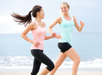 Young women jog on the beach